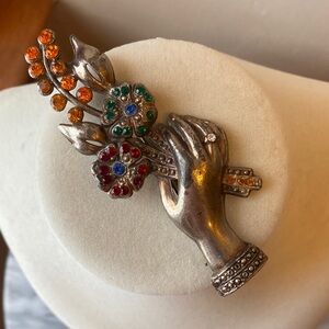 Vintage hand and floral bouquet brooch.
